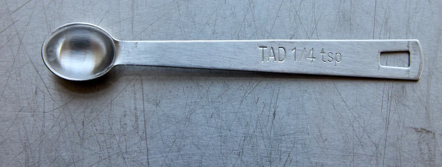 The stainless steel quarter-teaspoon measuring spoon