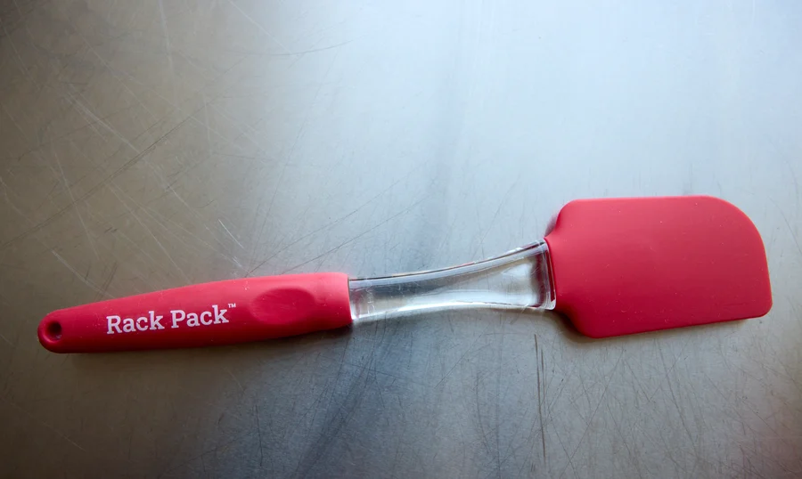 The red silicone Rack Pack spatula