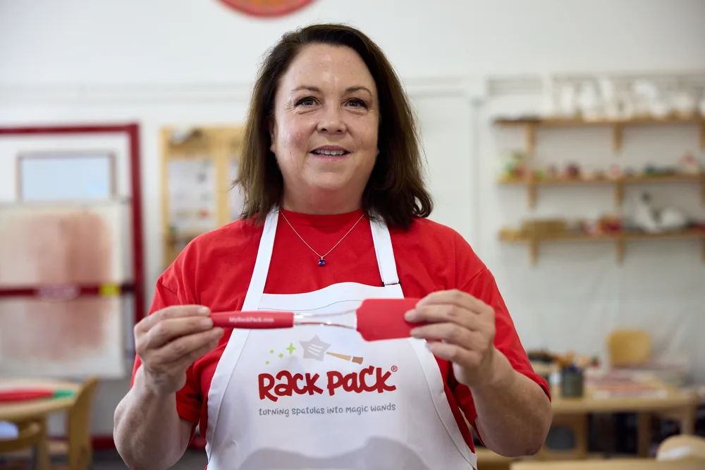 Liz Kupillas holding two Rack Pack spatulas